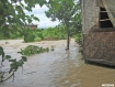 Flood waters from a bloated mountain stream threaten a thatched house in Taungphila ward, Kalay Township, in the northwest Burmese division of Sagaing, after a heavy downpour on Tuesday, July 27, 2010. About 50 houses were inundated and a six-year-old girl is missing. Photo: Mizzima