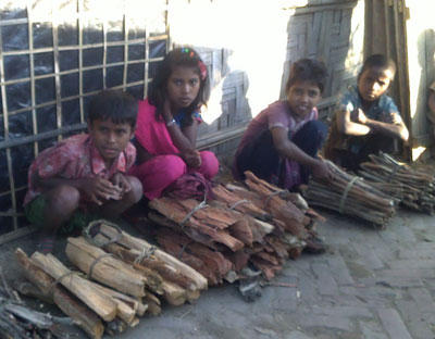 Unregistered refugee children from Leda Camp sell fire wood