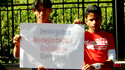 Two young Rohingya hold placard in front of Embassy