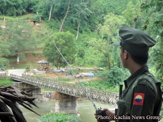 A KIA soldier takes position near Burmese frontline-base at Munglai Hka river bridge in Lajayang village on Myitkyina-Bhamo road.