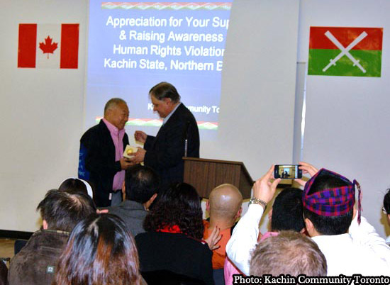 hair of the Canadian Burma Parlimentary caucus Jim Karygiannis embraces Kachin elder Dr. Maran La Raw at a meeting in Toronto January 7, 2012.