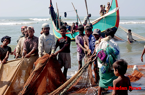 Rohingya fishermen tend to their nets