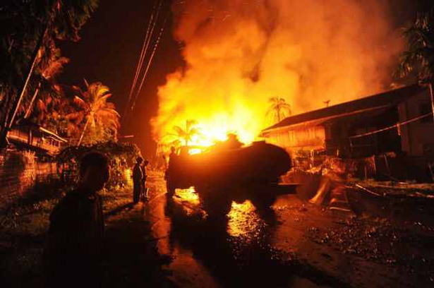 A-fire-truck-arrives-at-a-site-where-houses-are-on-fire-in-Sittwe