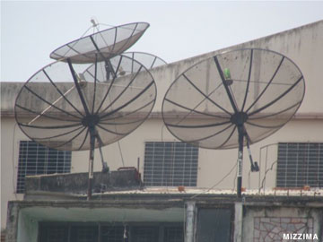 Satellite TV receivers located on a rooftop of a residential building in Rangoon. Photo – Mizzima