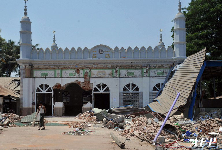 A man walks outside a partially-destroyed mosque in Gyobingauk, Bago region, on March 28, 2013, in the aftermath of anti-Muslim riots. (AFP)