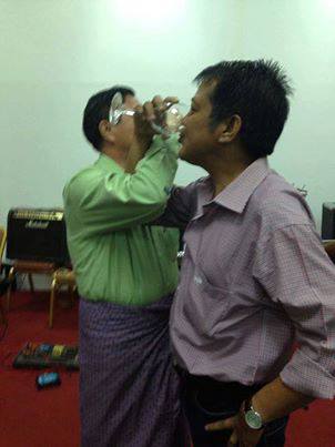 Chief peace government negotiator Minister U Aung Min and ABSDF Chairman Than Khe drink champagne after signing the ceasefire.