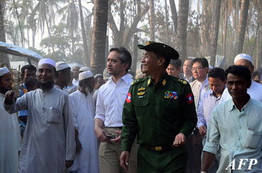 This handout picture picture taken on January 7, 2013, from the Indonesian Embassy shows Indonesian Foreign Minister Marty Natalegawa (center left) walking with local residents during a visit to Rakhine State. 