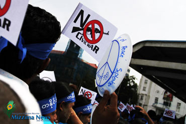 Demonstrators protesting the ongoing conflict in Kachin State march through the streets of Rangoon on September 21, 2012, to mark International Peace Day. (Ye Min / Mizzima)