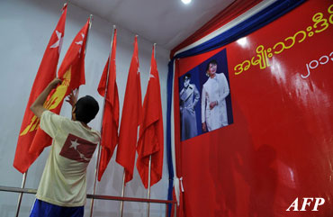 A worker arranges flags as part of preparations for the National League for Democracy party congress at the Royal Rose Hall in Yangon. (AFP PHOTO)