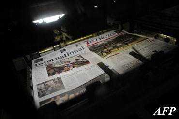 This picture taken on March 26, 2013, shows newspapers coming out of a printer at a printing house in Yangon.(AFP)