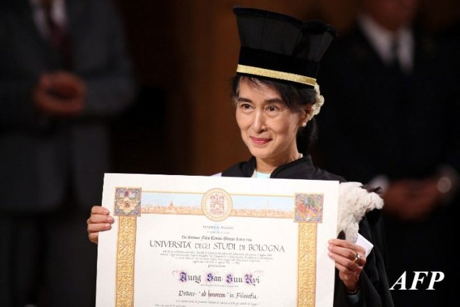 Nobel Peace Laureate and Myanmar opposition leader Aung San Suu Kyi poses after receiving a degree of philosophy at the Bologna University on October 30, 2013 in Bologna. AFP PHOTO