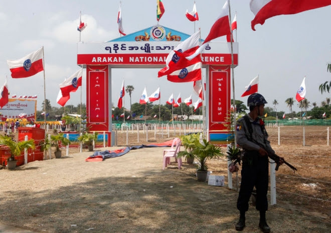 An armed policeman stands near the entrance