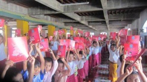 Students Holding up Their Mon Text Books