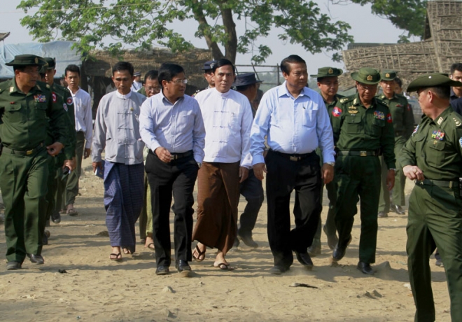 Myanmar vice president Nyan Tun (L-C), Prime Minister of Rakhine State Hla Maung Tin (C) and Union Minister of Immigration Khin Ye (R-C) walk together with high-ranking military officers as they arrive to check taking Myanmar's nationwide census at Bu Min Muslim majority village near Sittwe of Rakhine State, western Myanmar, 30 March 2014. EPA/NYUNT WIN