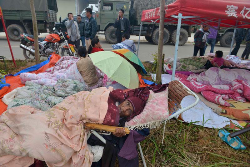 Homeless people rest in a temporary settlement for the quake victims in Yongping township of Jinggu county in Yunnan province, China, October 8 2014. EPA/ZHANG YQ CHINA OUT