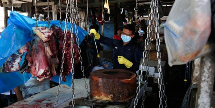 A staff member of the Yangon City Development Committee disinfects Pazontaung market, as a preventive measure against the spread of the COVID-19 novel coronavirus, in Yangon on March 21, 2020. Photo: Sai Aung Main/AFP