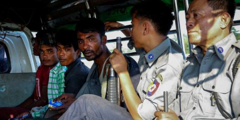 (File) Rohingya men escorted by armed policemen sit in a light truck at the KyaukTan township, south of Yangon, Myanmar, 16 November 2018. Photo: EPA