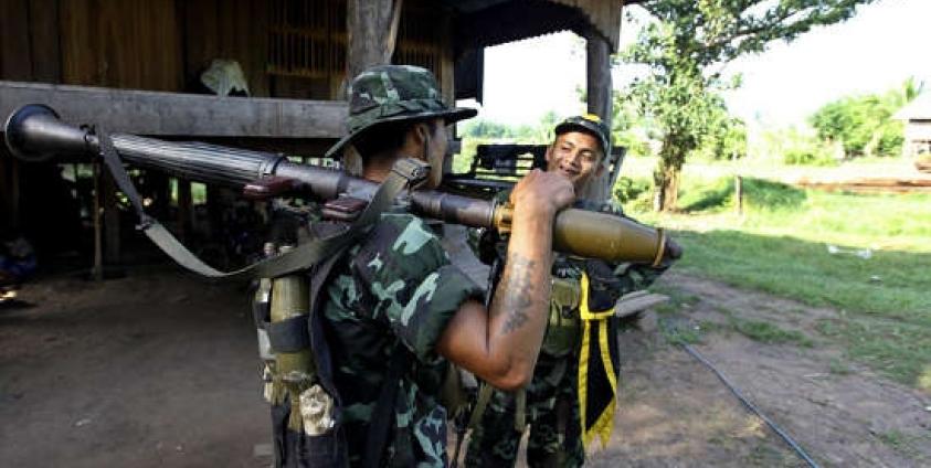 Soldiers from Democratic Karen Buddhist Army (DKBA) take guard at Democratic Karen Buddhist Army (DKBA)'s Kawthumweke front line camp, Myawaddy, Karen State, Myanmar, 10 May 2012. Photo: Nyein Chang Naing/EPA