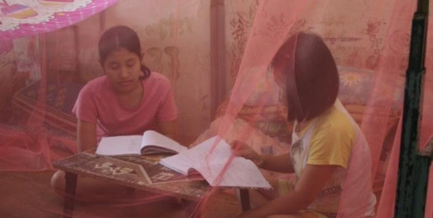 Students are studying inside the mosquitos Net donated by Ms. Gale, BCTFN, at school dormitory - Photo by Aya Tabata