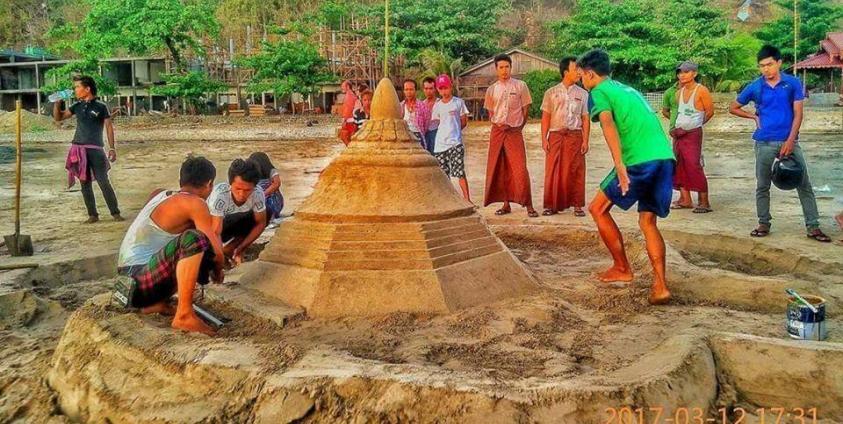 People are setting up sand stupa 