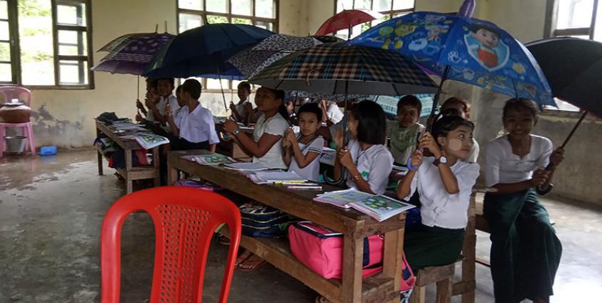 Caption: An old school building in Nyaung Chaung Thit village, Ann Township, and a new school building locked by the construction company. (Photo: DMG)