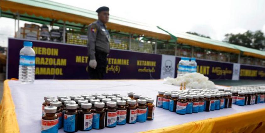 A Myanmar police officer stands near a pile of illegal drugs during a 'Destruction Ceremony of Seized Narcotic Drugs', held to mark the International Day against Drug Abuse, in Yangon, Myanmar, 26 June 2019. Photo: Nyein Chan Niang/EPA