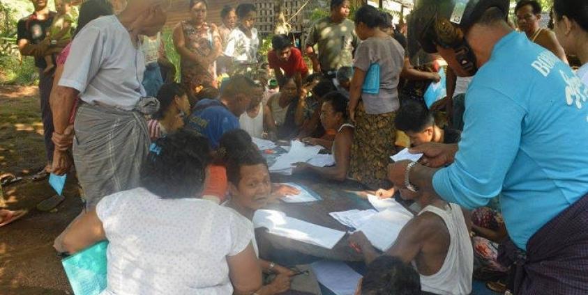 Voter registration cards being issued at a ward and village election sub-commission office in Kawkareik, Karen State.