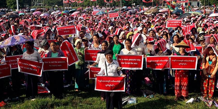 Kachin people hold placards reading 'For a more peaceful day, war is not the way.' and 'Stop civil war in Kachin State' during a protest held to show opposition to the conflict between the Myanmar Army and Kachin Independence Army (KIA) in Kachin State, in Myitkyina, Kachin State, Myanmar, 3 October 2016. Photo: Seng Mai/EPA