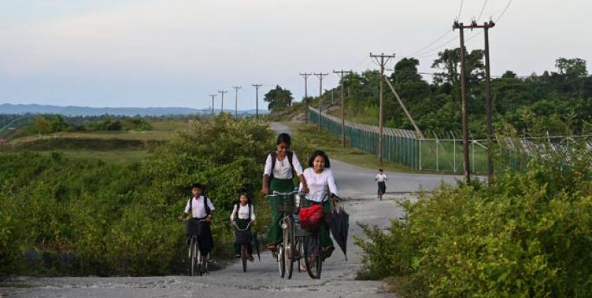 Students riding their bicycles outside the Daewoo facility in Kyaukphyu, Rakhine State. Photo: Ye Aung Thu/AFP