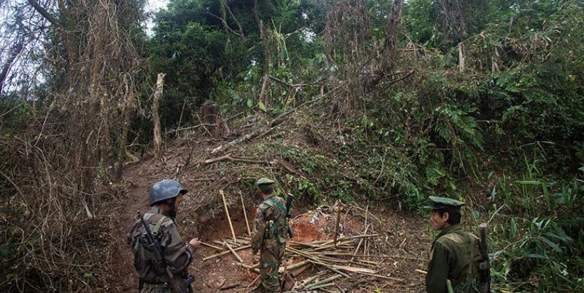 In this photograph taken October 13, 2016, armed rebels belonging to the Kachin Independence Army (KIA) ethnic group inspect the frontline after it was hit by a military bomb during two days of fighting with the Myanmar military near Laiza in Kachin State. Photo: Hkun Lat/AFP