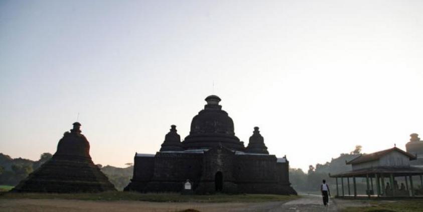 A maan walks along the road near ancient pagodas in Mrauk U, Rakhine State. Photo: Nyunt Win/EPA