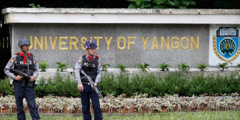 Armed police officers stand guard in Yangon. Photo: EPA