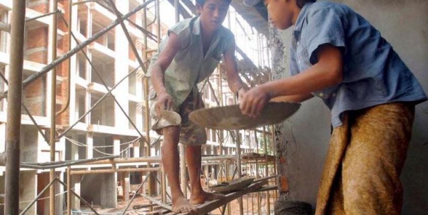 Child construction workers at work on a building site in Yangon. Photo: EPA