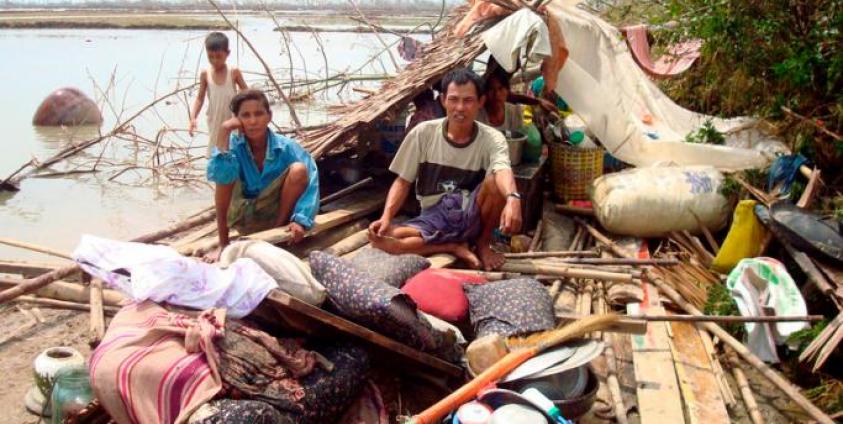 A Myanmar family sits on the remains of their house in Bogolay, the Irrawaddy Delta, 14 May 2008. Photo: EPA