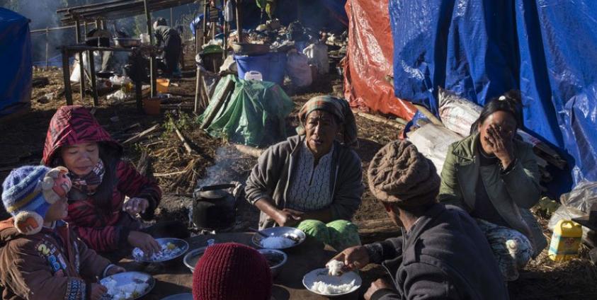 A Kachin refugee family eating near Lung Byeng village in Waimaw township in Kachin state. Photo: Hkun Lat/AFP