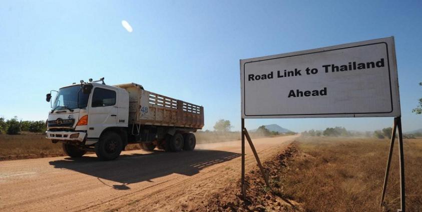 A truck passing a sign read "Road Link to Thailand Ahead" at Dawei Special Economics Zone 