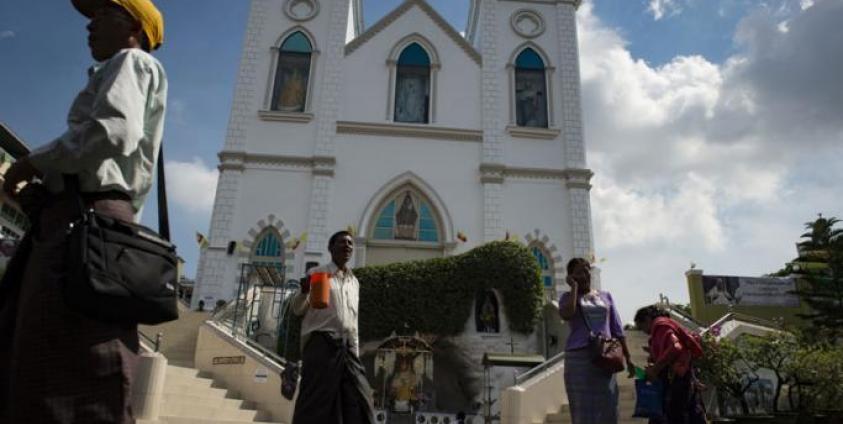 Catholics from Myanmar walk in front of St. Anthony Church in Yangon. Photo: AFP