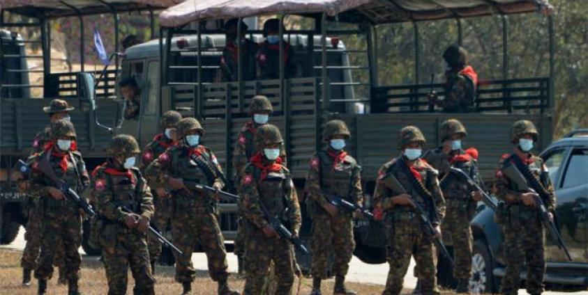 Soldiers stand guard as they block a road near a prison in Naypyidaw on February 15, 2021, after the military seized power in a coup. Photo: AFP