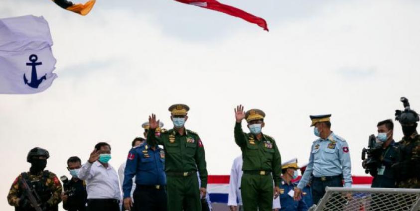 Myanmar armed forces chief Senior General Min Aung Hlaing (4th R) waves during the inauguration of a new military coastguard in Yangon on October 6, 2021. STR / AFP