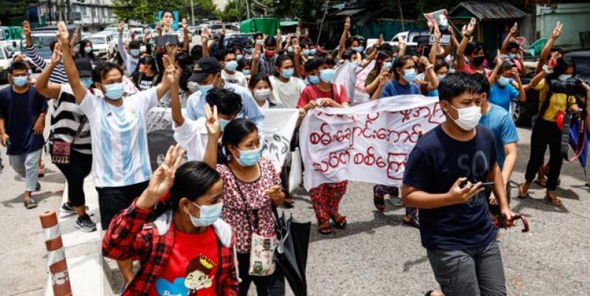 Protesters make the three-finger salute as they take part in a demonstration against the military coup and mark the birthday of Myanmar's detained civilian leader Aung San Suu Kyi in Yangon on June 19, 2021. Photo: AFP