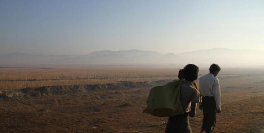 Three people walk along a road in Buthidaung township, Rakhine State. Photo: Richard Sargent/AFP