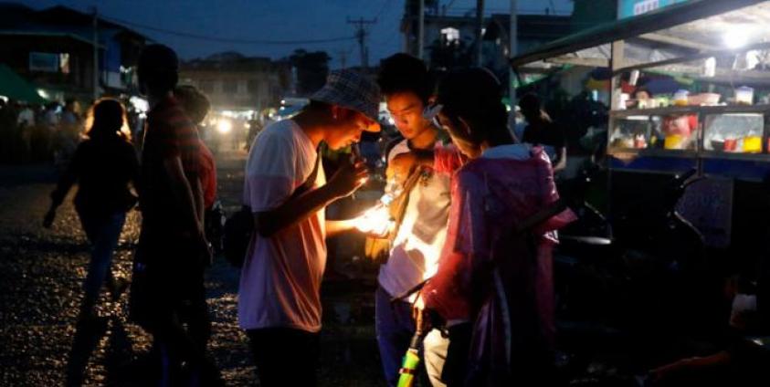 A buyer checks a Jade stone at the LoneKhin night market in Hpakant, Kachin State, northern Myanmar. Photo: Nyein Chan Naing/EPA