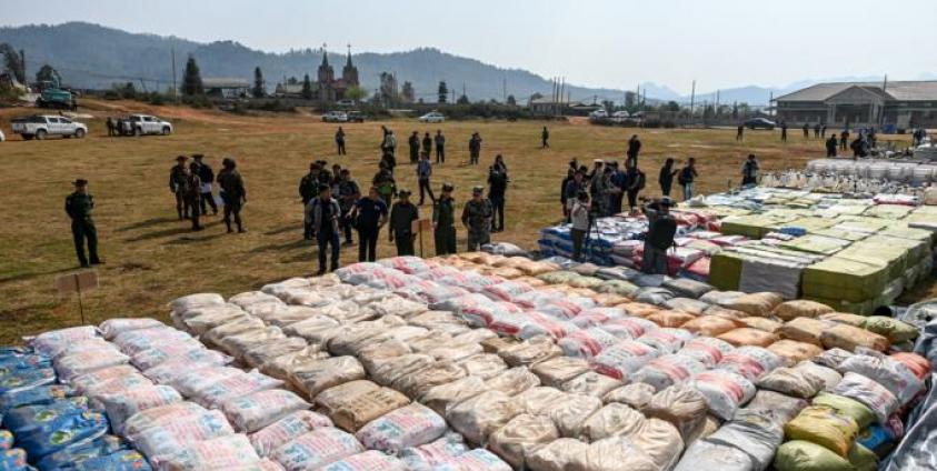 (File) Foreign military attaches check drugs in a football ground where seized drugs, vehicles, laboratory accessories and precursor chemicals are being displayed to be witnessed by invited military attaches and journalists in Kawnghka at Shan State on March 6, 2020. Photo: Ye Aung Thu/AFP 