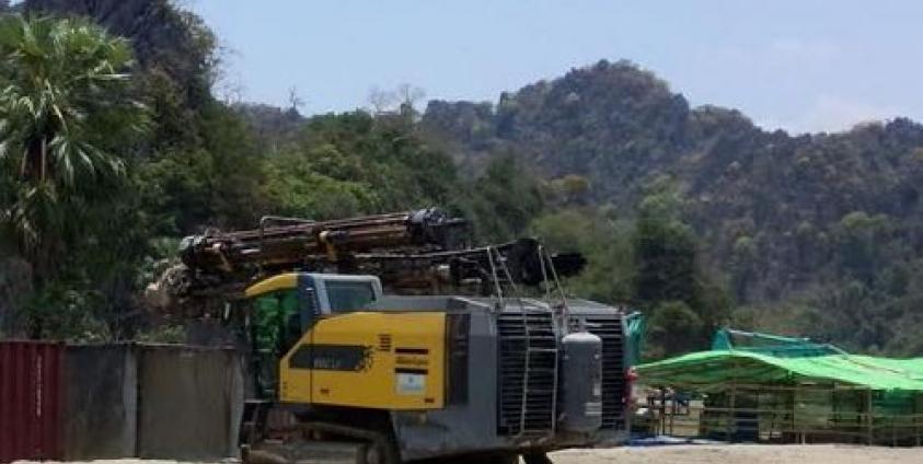 A machine levels the ground at the site of a cement factory in Kyaikmaraw township, Mon State