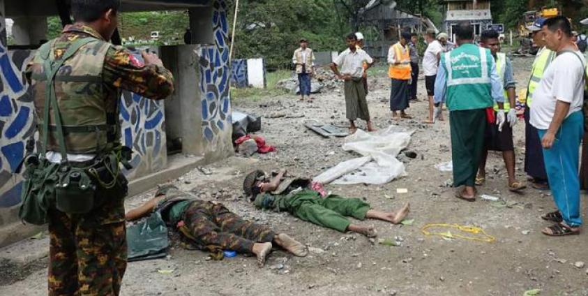 People look at bodies lying on the ground in the compound of the Gote Twin police station in Shan State on August 15, 2019, after it was attacked by ethnic rebel groups. Photo: AFP