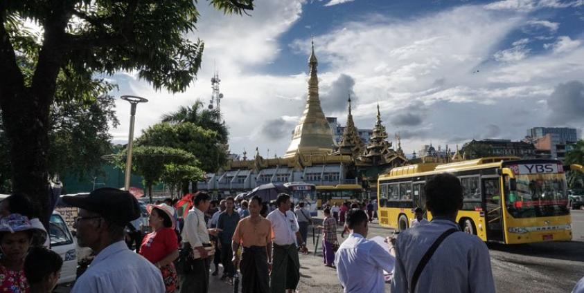 People walking in front of the Sulay Pagoda in downtown area of Yangon. Photo: Ye Aung Thu/AFP