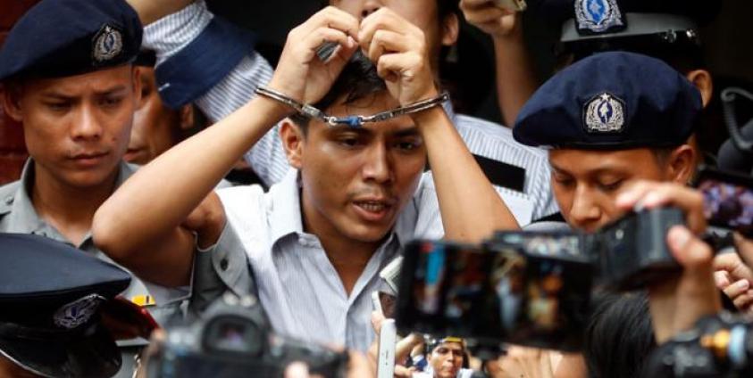 Reuters journalist Kyaw Soe Oo (C) is escorted out of the Insein township court in Yangon, Myanmar, 03 September 2018. Photo: Lynn Bo Bo/EPA