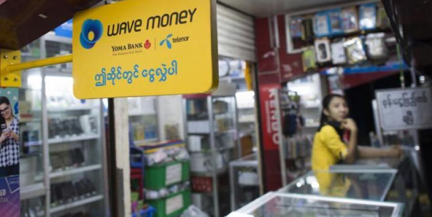 A signboard for mobile banking firm Wave Money at a telecommunications shop in downtown Yangon. Photo: AFP