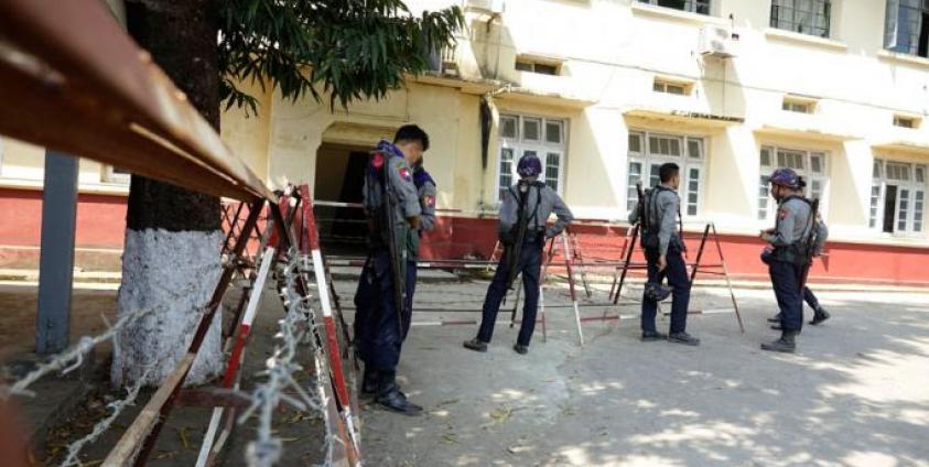 Armed police officers stand guard near Sittwe Court. Photo: Nyunt Win/EPA