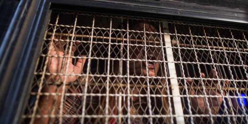 A demonstrator shouts from inside a prison van after being detained by Myanmar police during an anti-war protest in Yangon on May 12, 2018. Photo: Sai Aung Main/AFP